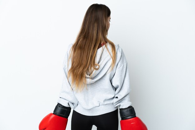 Young sport woman over wall with boxing gloves