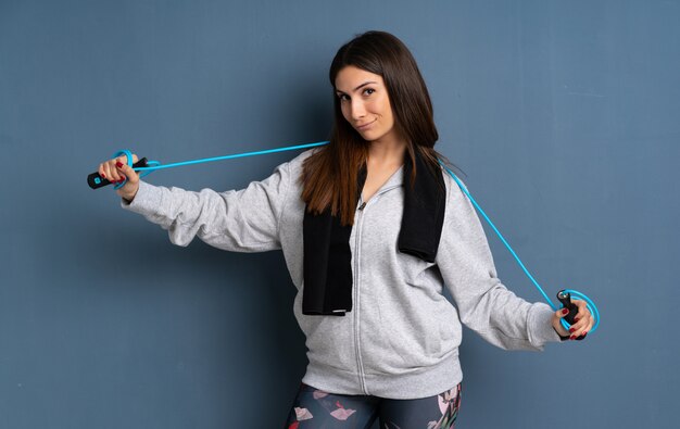 Young sport woman with jumping rope