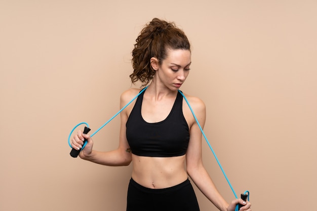 Young sport woman with jumping rope