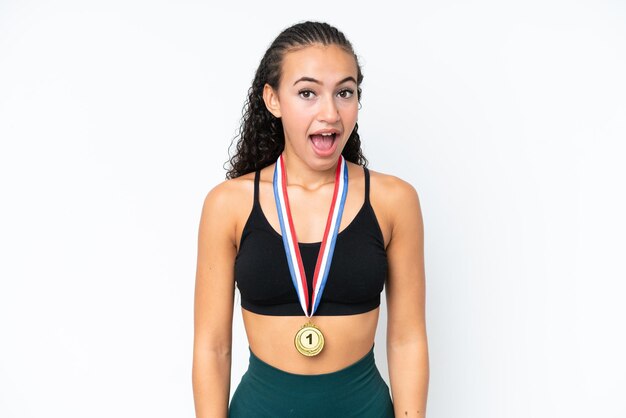 Photo young sport woman with medals isolated on white background with surprise facial expression