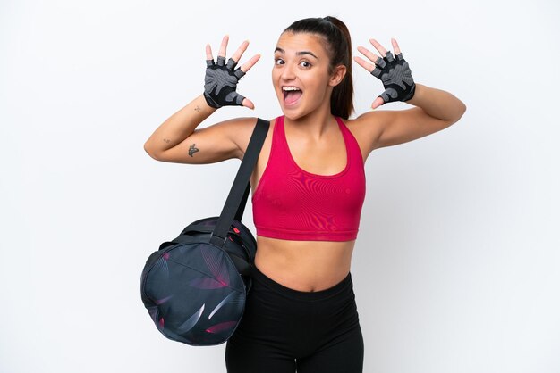 Young sport woman with sport bag isolated on white background counting ten with fingers