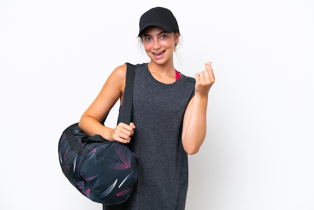 Young sport woman with sport bag isolated on white background
making money gesture