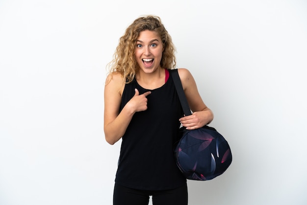 Young sport woman with sport bag isolated on white background with surprise facial expression