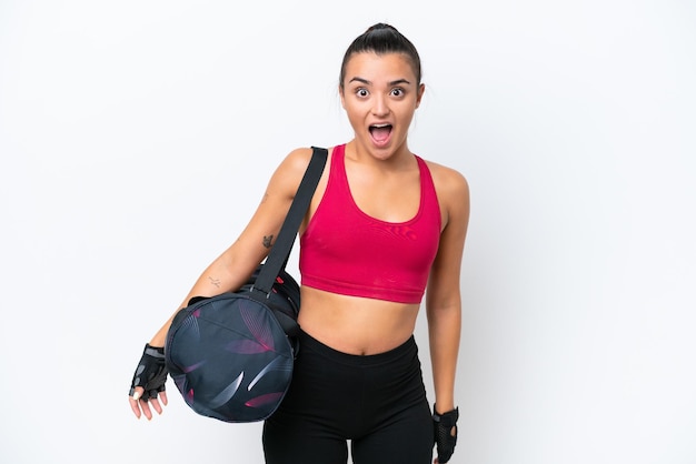 Young sport woman with sport bag isolated on white background with surprise facial expression