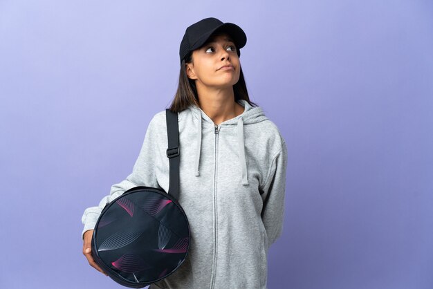 Young sport woman with sport bag and looking up