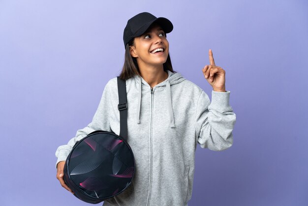 Young sport woman with sport bag pointing up a great idea