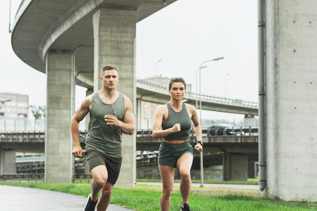 Young sportive couple during jogging workout on city street