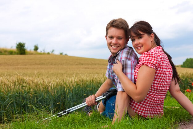 Young sportive couple posing with hiking sticks