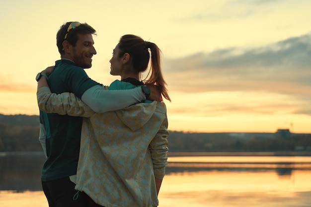 Young sportive couple at sunset