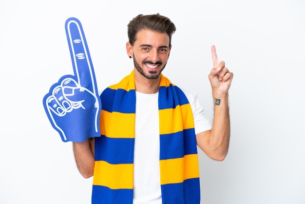 Young sports fan man isolated on white background pointing up a great idea