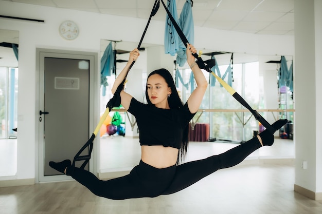 Young sports girls and boy are engaged in fitness lifestyle sports and healthy eating in the gym girls do exercisesgirl doing twine in the air high quality photo