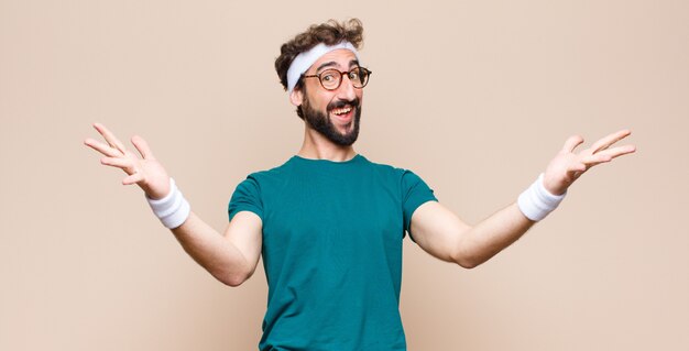 Young sports man expressing a concept against flat wall