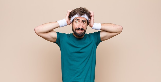 Photo young sports man expressing a concept against flat wall