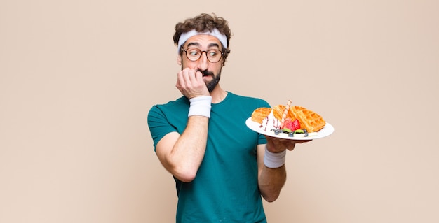 Young sports man with waffles. diet concept