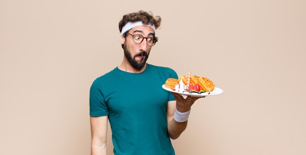 Young sports man with waffles. diet concept