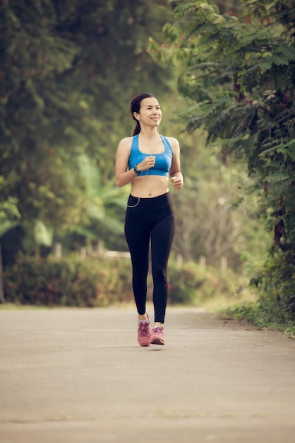 young sports woman runner running on road