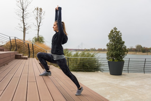 Young sports woman stretching legs