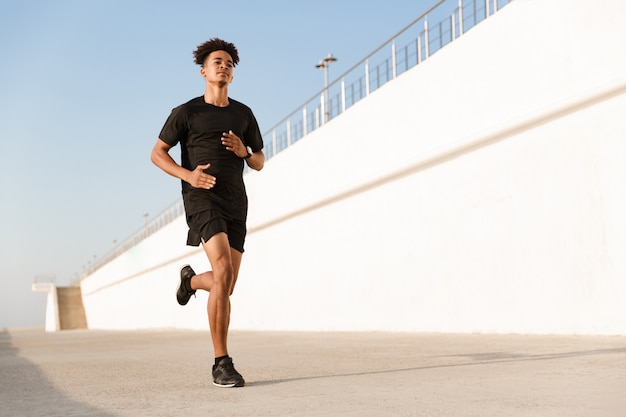 Young sportsman outdoors on the beach running