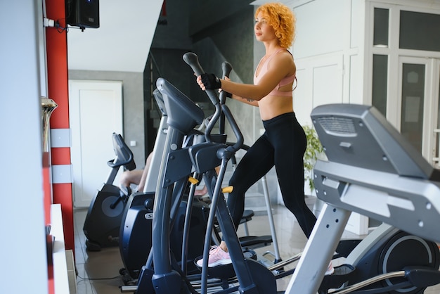 Young sportswoman working out in gym