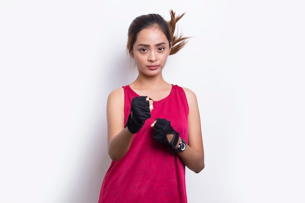 Young sporty asian beautiful showing fist gesture on white background