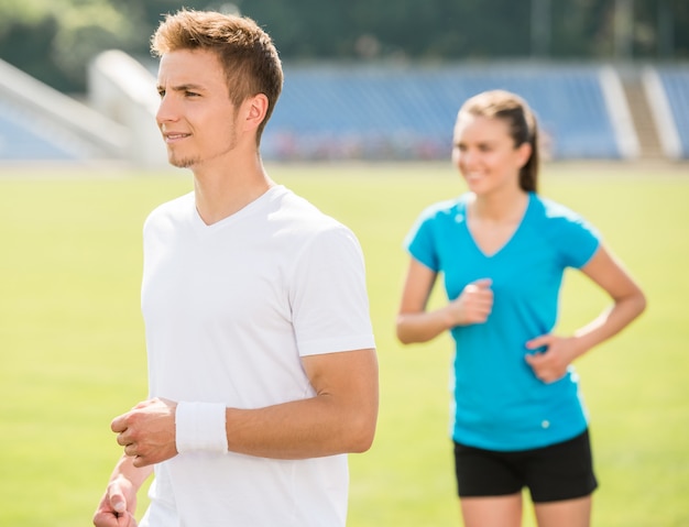 Young sporty couple jogging together.