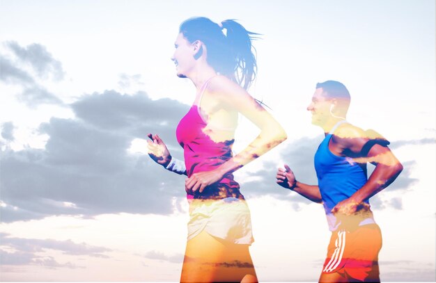 Photo young sporty couple running outdoors on cloudy sky background