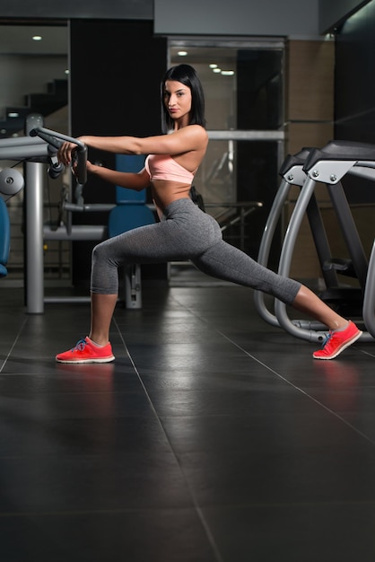 Young Sporty Fit Woman Stretches In Gym