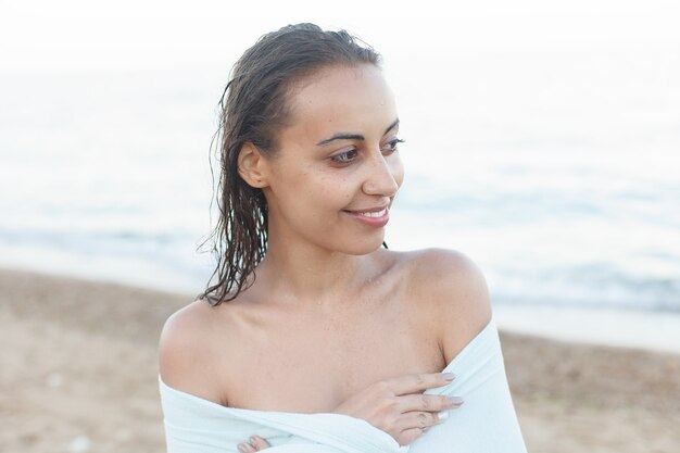 Young and sporty girl posing on a beach at summer