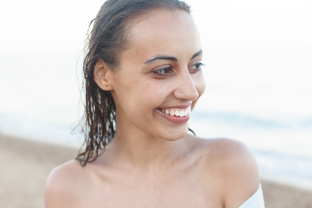 Young and sporty girl posing on a beach