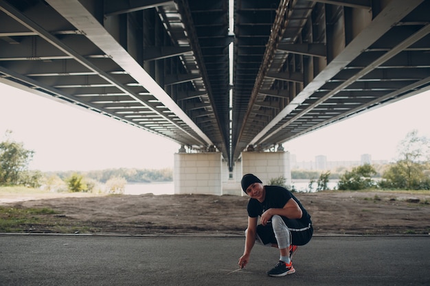 Young sporty guy doing parkour at the city street.