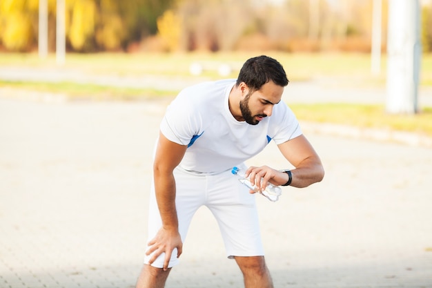 Young and sporty man training outdoor in sportswear