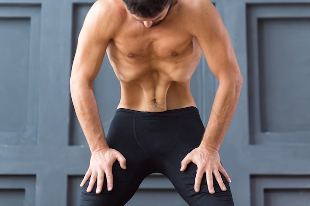 Young sporty men practicing Upward abdominal lock