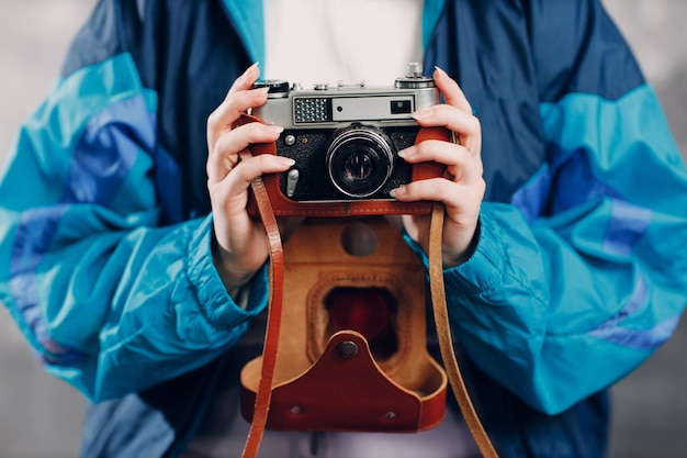 Young sporty woman 80 and 90s style 90s fashion positive girl with old camera