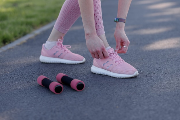 Young sporty woman doing sports outdoors fitness exercises