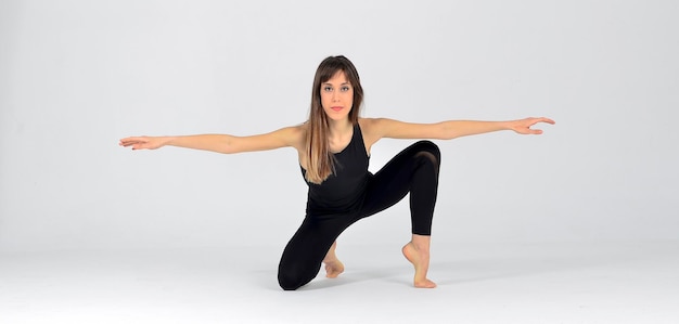 Young sporty yogi woman practicing yoga,doing pose, working out, wearing black sportswear