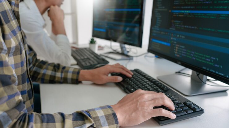 Photo young startup programmers sitting at desks working on computers screen for developing programming and coding to find solution to problem on new application.