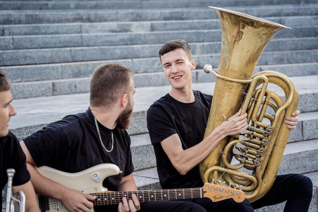 Young street music band play a lot of musical instruments