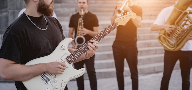 Young street music band play a lot of musical instruments