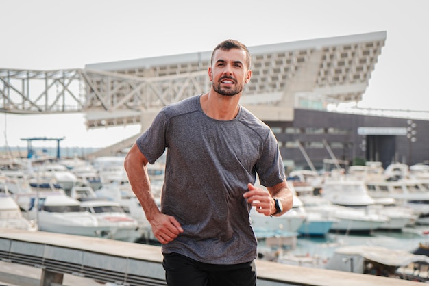 Young and strong male running for health wellness or training for a marathon competition or race