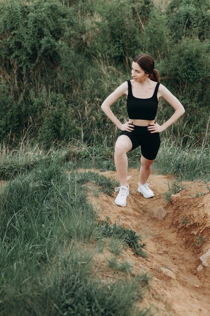 Young strong woman climbs to top of cliff overcoming obstacles
and courage ambitious climber climb