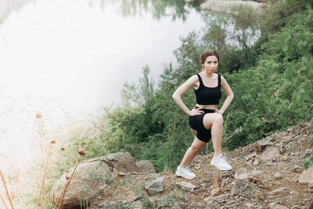 Young strong woman climbs to top of cliff overcoming obstacles\
and courage ambitious climber climb