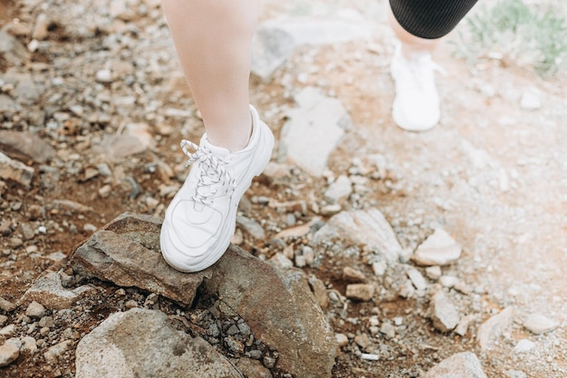 Young strong woman climbs to top of cliff overcoming obstacles\
and courage ambitious climber climb