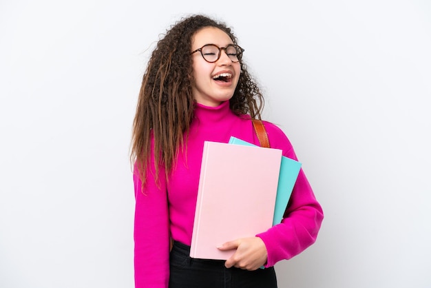 Young student Arab woman isolated on white background laughing