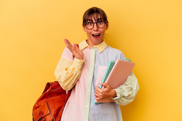 Young student Argentinian woman isolated on yellow background surprised and shocked.