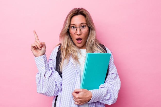 Young student australian woman isolated on pink background having some great idea, concept of creativity.