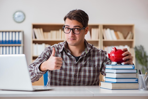 Young student breaking piggy bank to buy textbooks