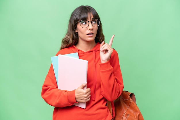 Young student caucasian woman over isolated background thinking an idea pointing the finger up