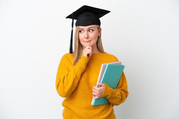 Young student caucasian woman isolated on white background having doubts and thinking