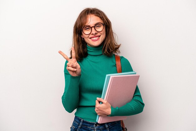 Young student caucasian woman isolated on white background showing number two with fingers