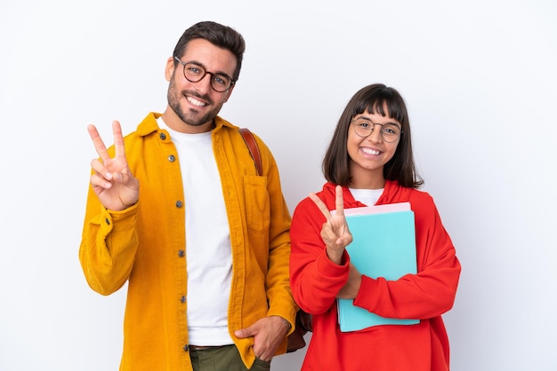 Young student couple isolated on white background smiling and showing victory sign